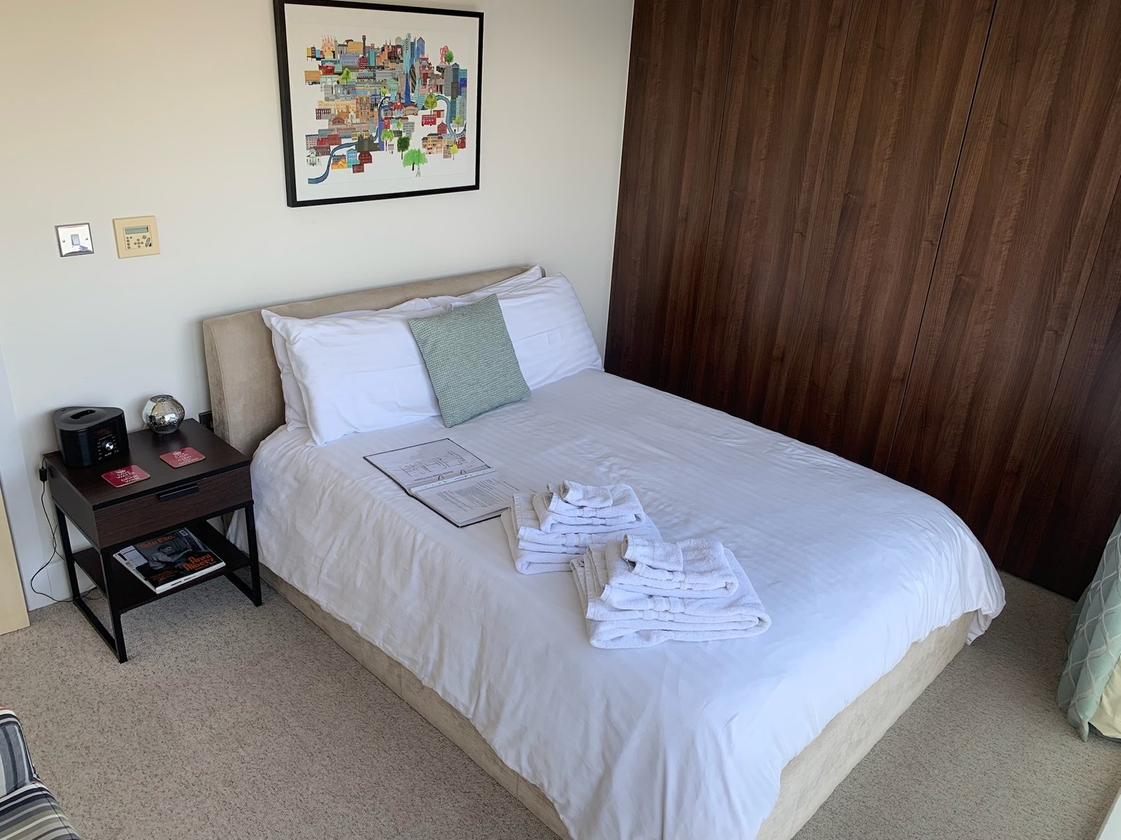 Guest bedroom with built-in walnut wardrobe, set up as the Airbnb room