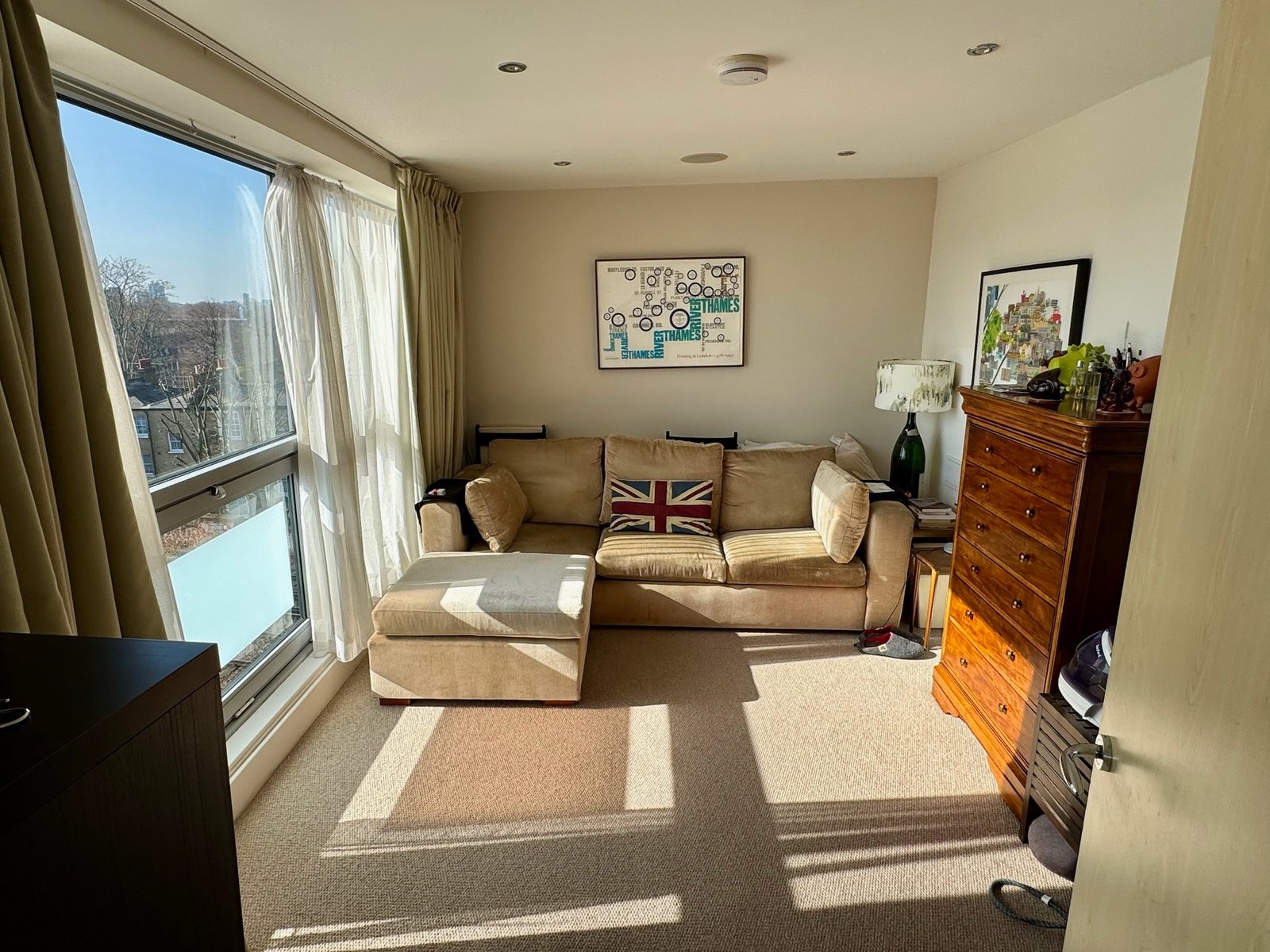 Second sitting room with floor-to-ceiling window and beige sectional